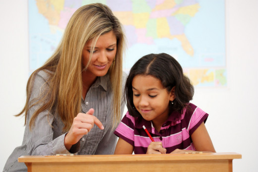  Elementary Teacher helping Student